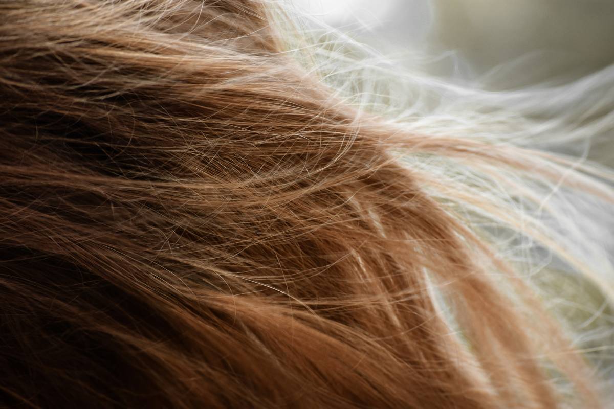 Woman demonstrating Low-Tension Options for hair twists with loose root technique