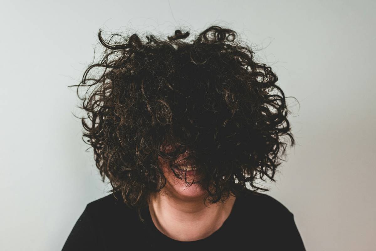 Woman styling hair twists with fingers for Natural Look using matte finish products