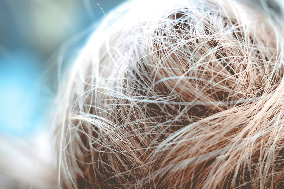 Woman with loose two-strand twists styled Safe for Edges showing zero tension at hairline
