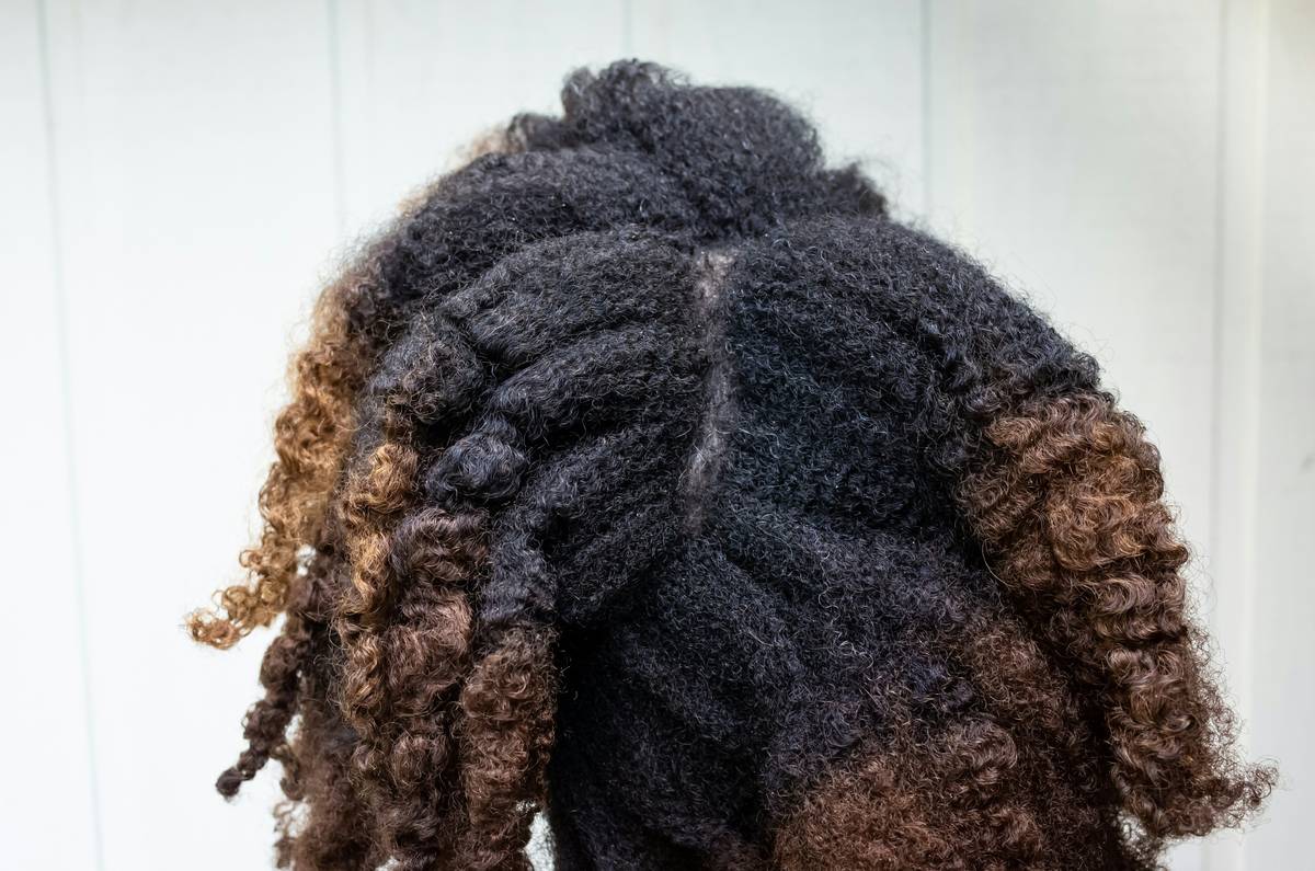 Gentle Styling demonstration showing loose, defined hair twists on natural hair with visible scalp comfort